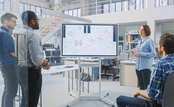 Woman discussing in front of her colleagues inside a facility