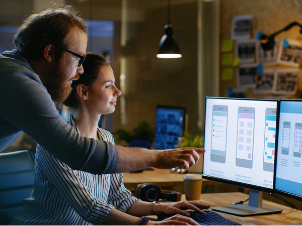 UX designer showing her work to a colleague
