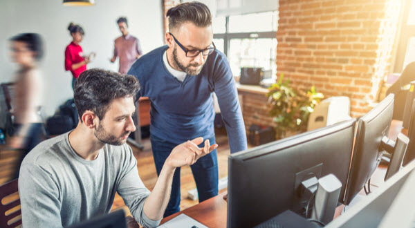 Two men discussing about coding
