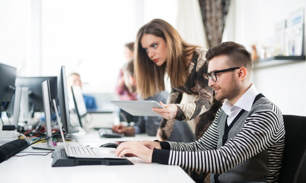 Woman checking the work of her colleague