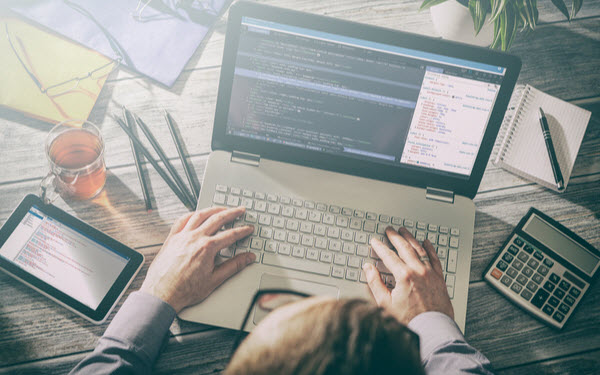 Developer coding on his laptop